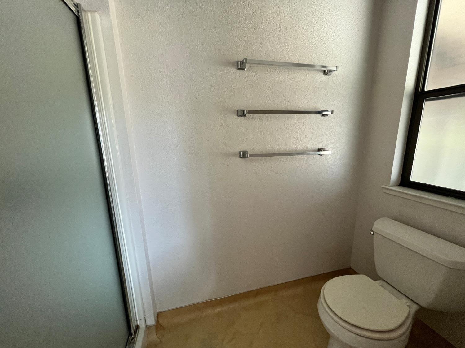312 Roxanne Drive Patterson, CA 95363 - Photo 25 of 28 a white toilet sitting next to a small window