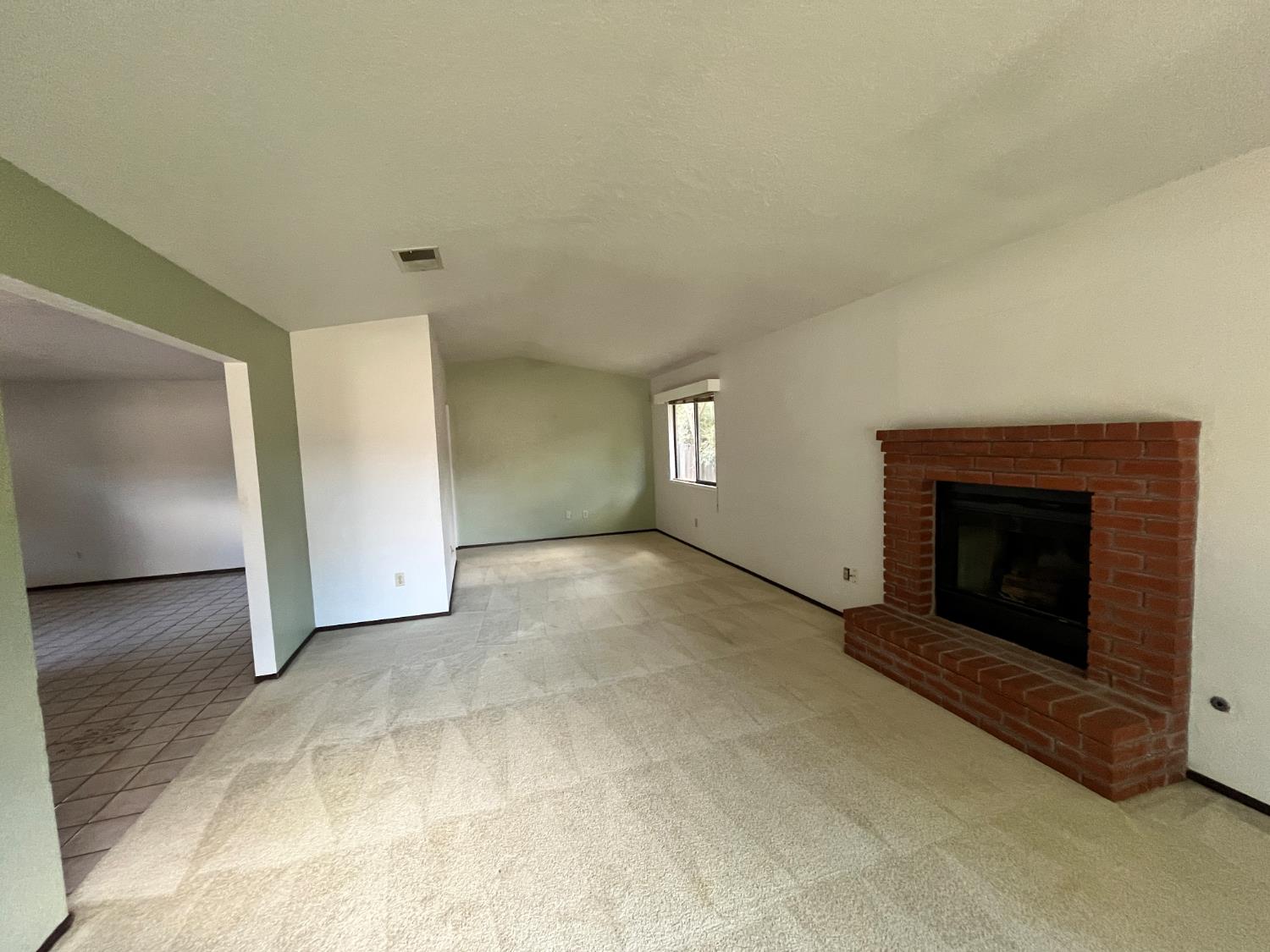 312 Roxanne Drive Patterson, CA 95363 - Photo 8 of 28 a view of empty room with a fireplace