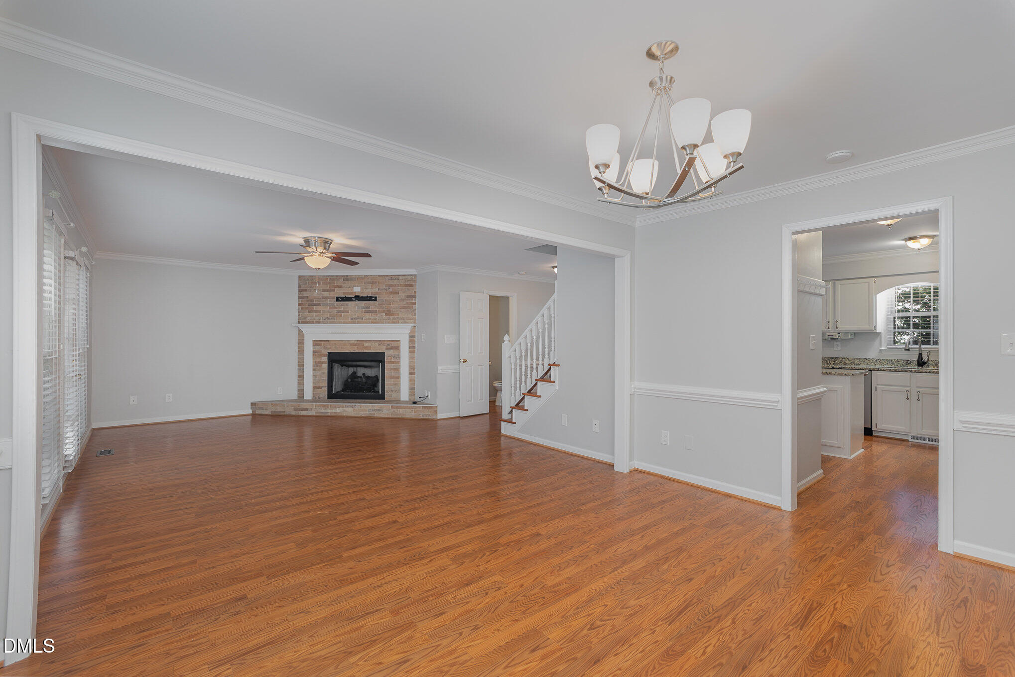 1437 Greenside Drive Raleigh, NC 27609 - Photo 11 of 27 a view of a livingroom with wooden floor and kitchen space