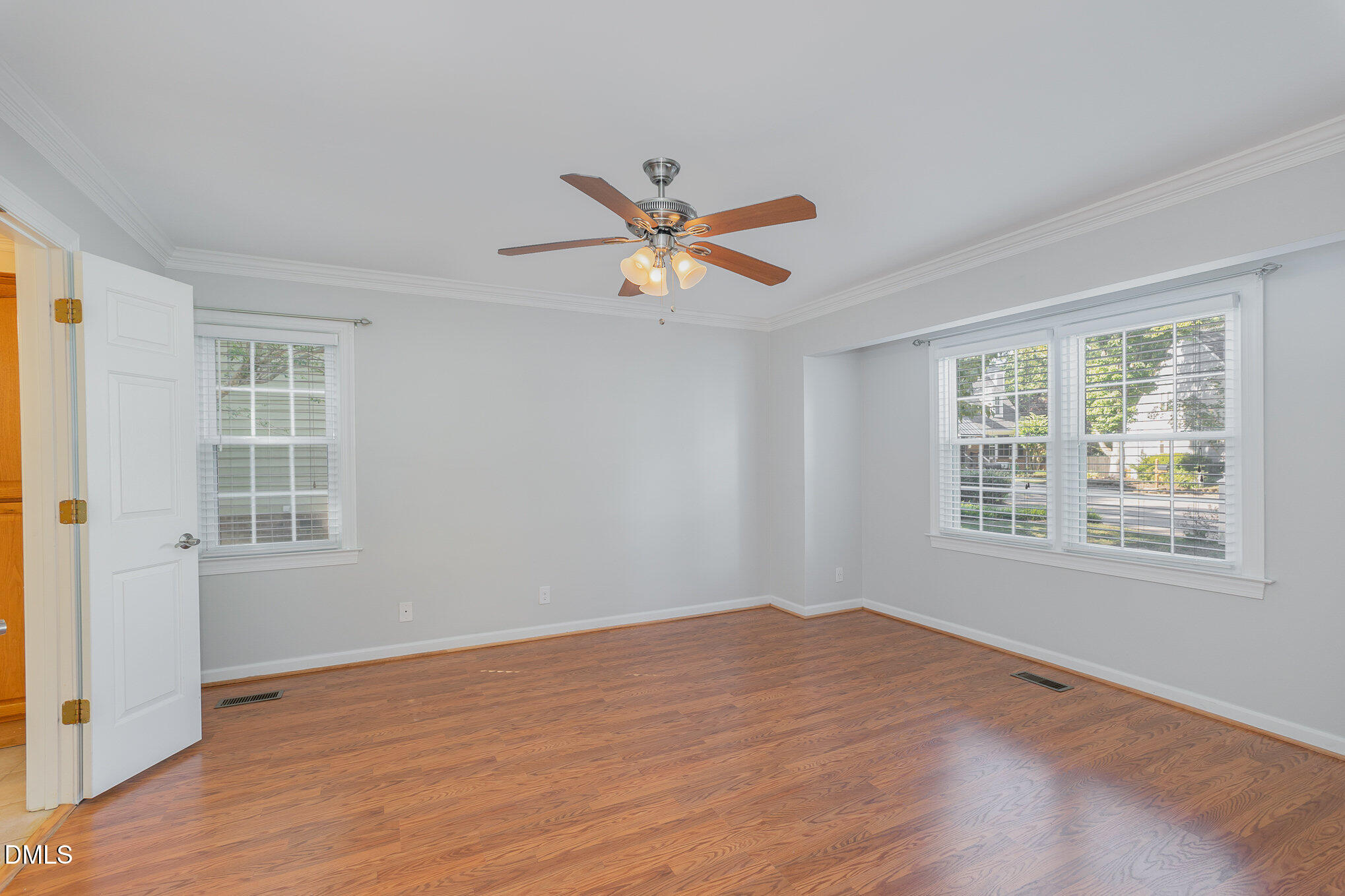 1437 Greenside Drive Raleigh, NC 27609 - Photo 13 of 27 a view of an empty room with a window and wooden floor