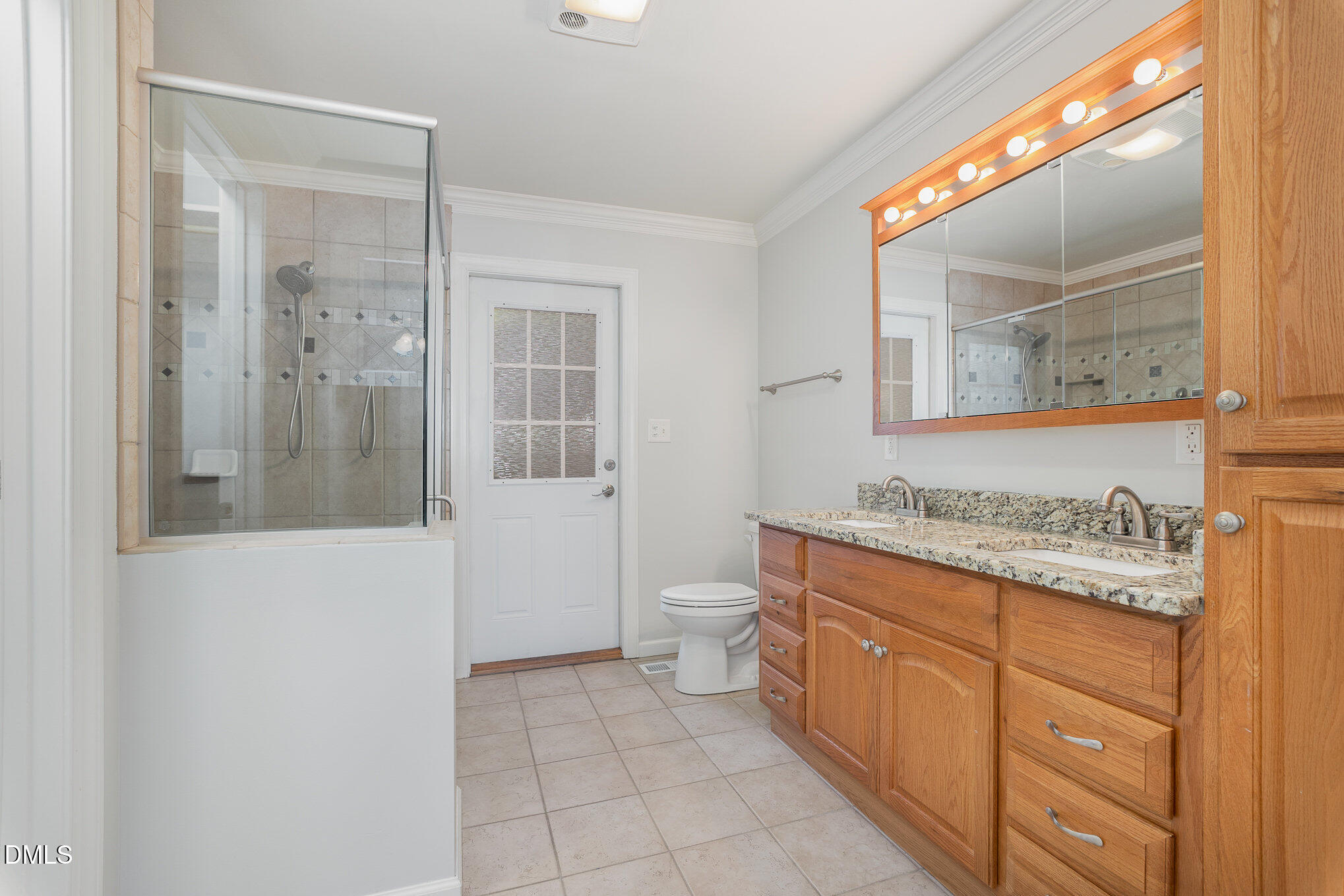 1437 Greenside Drive Raleigh, NC 27609 - Photo 15 of 27 a bathroom with a granite countertop sink a toilet and a mirror
