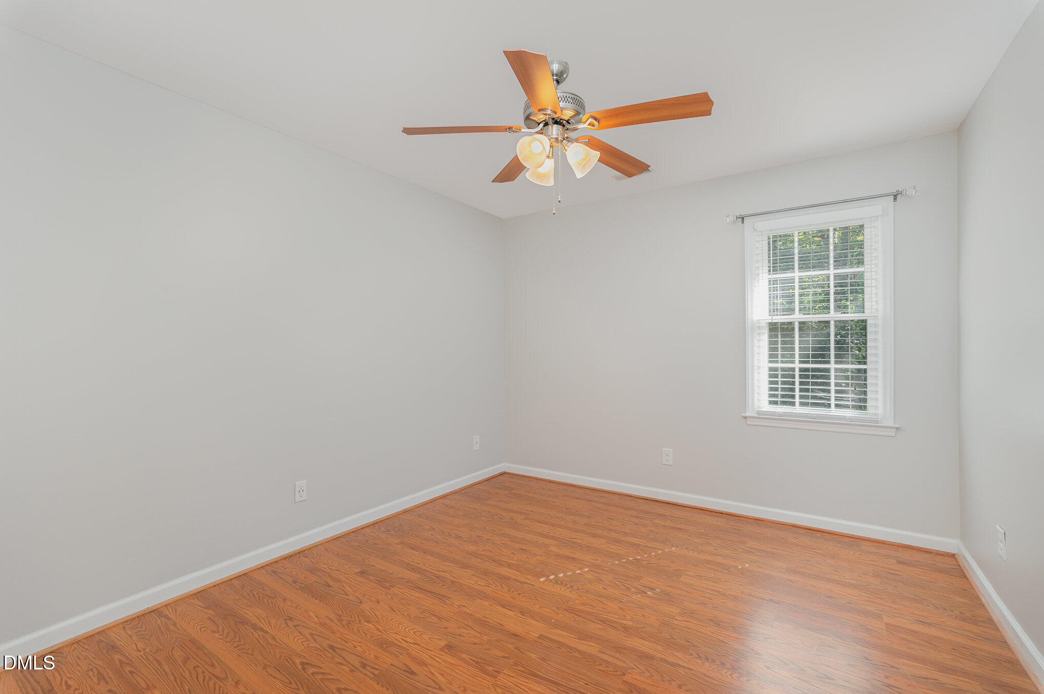 1437 Greenside Drive Raleigh, NC 27609 - Photo 18 of 27 an empty room with wooden floor and windows
