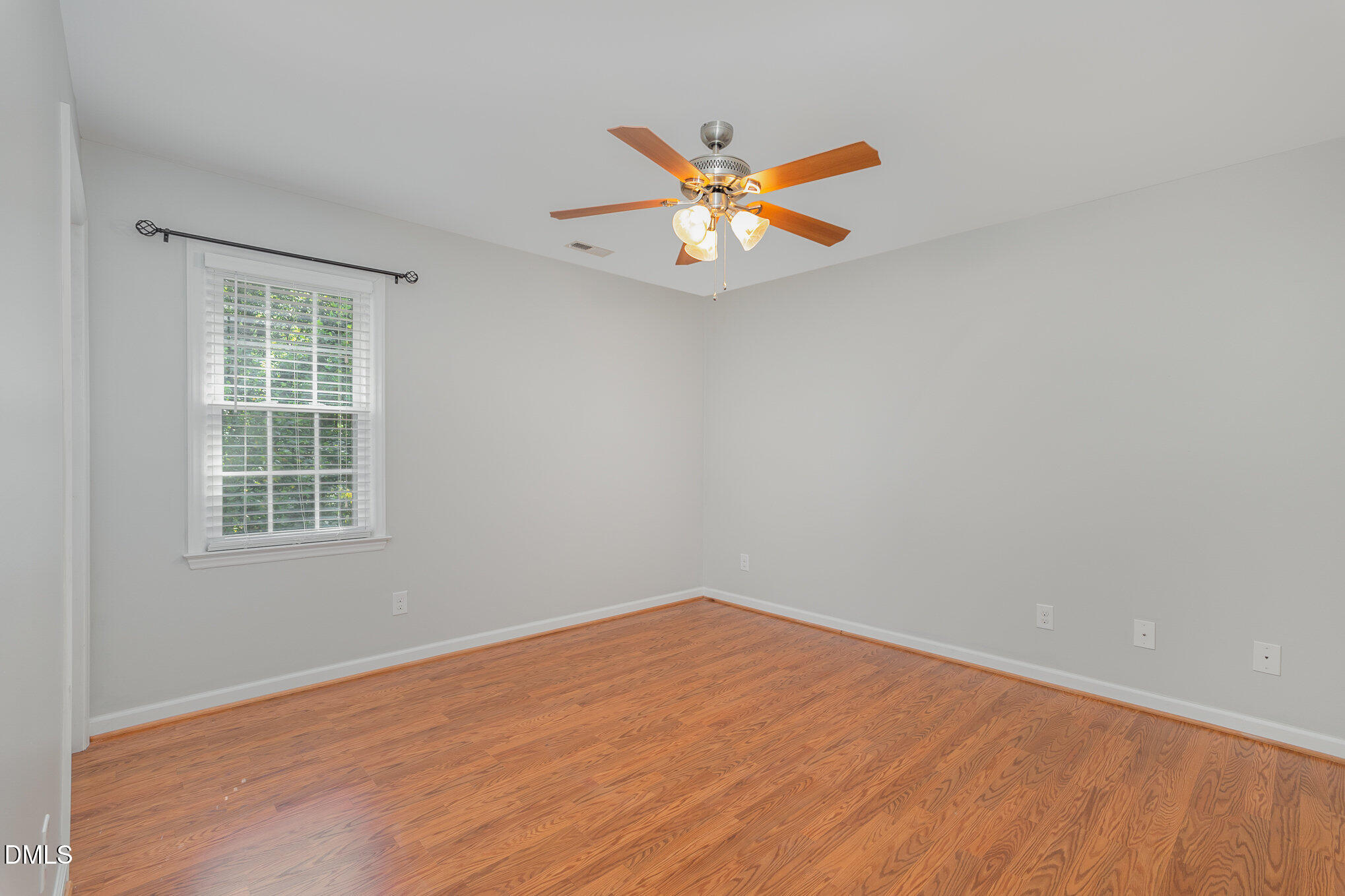 1437 Greenside Drive Raleigh, NC 27609 - Photo 19 of 27 an empty room with a window and ceiling fan
