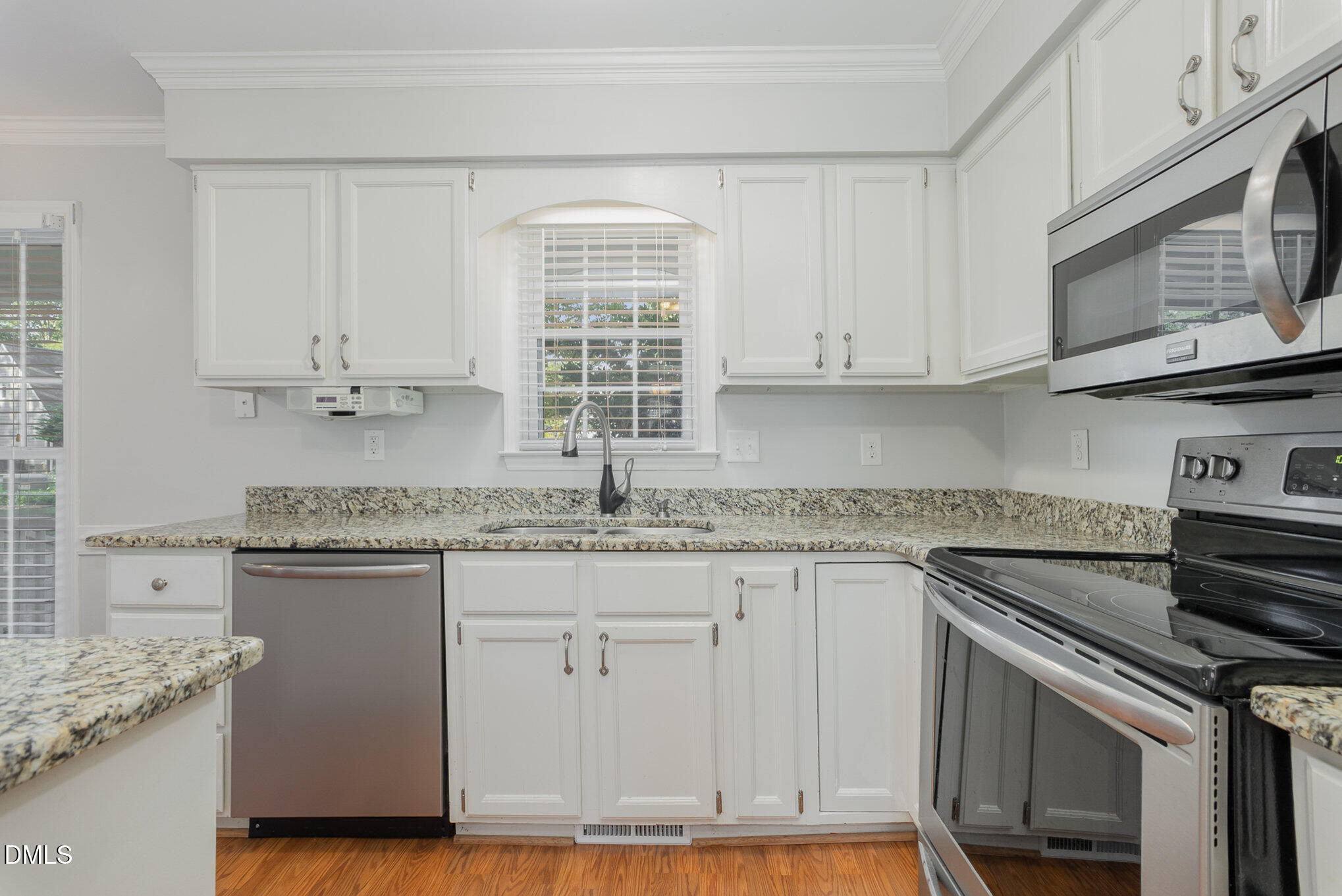 1437 Greenside Drive Raleigh, NC 27609 - Photo 8 of 27 a kitchen with stainless steel appliances granite countertop a sink and a stove