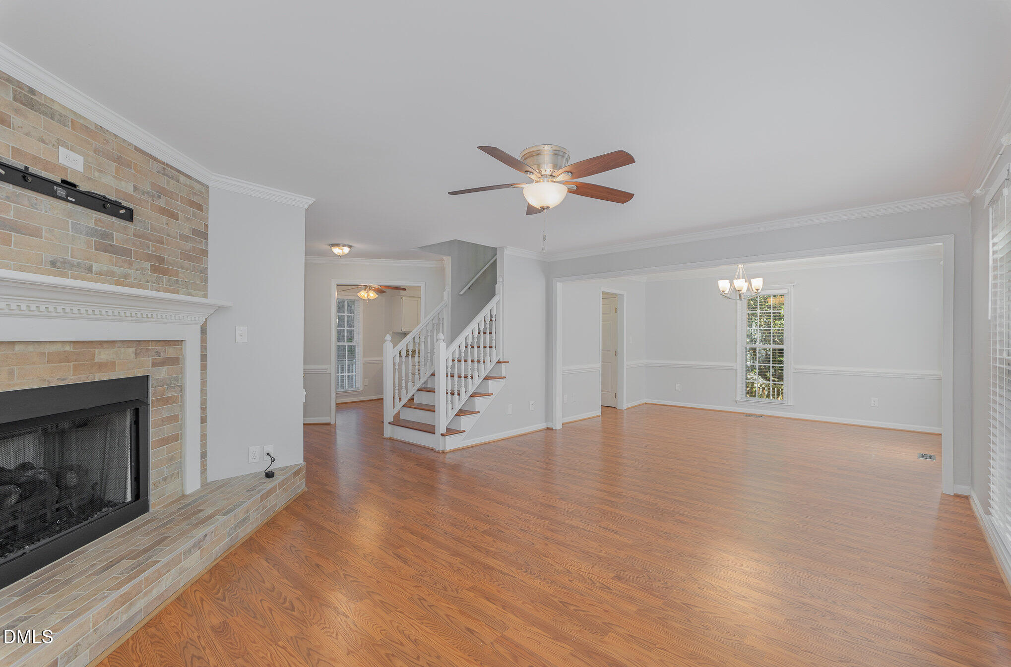 1437 Greenside Drive Raleigh, NC 27609 - Photo 9 of 27 a view of an empty room with wooden floor fireplace and a window