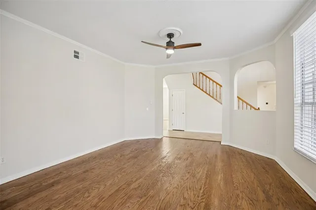 a view of a kitchen with stainless steel appliances granite countertop a dishwasher a stove a microwave oven with wooden floor