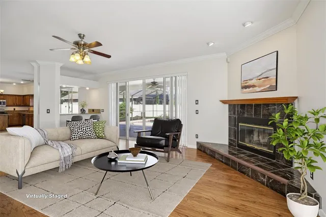 a living room with furniture and wooden floor