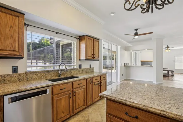 a kitchen with kitchen island granite countertop a counter space cabinets and stainless steel appliances