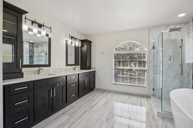 a spacious bedroom with a large bed and a chandelier