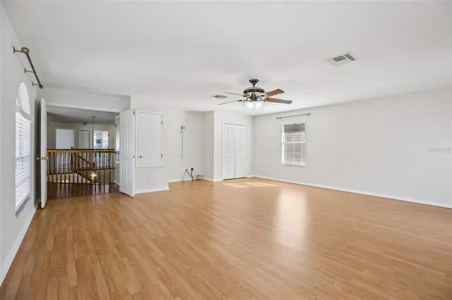 a view of an empty room with wooden floor