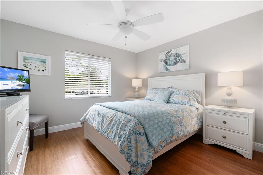 4572 Andover Way, Unit C105 Naples, FL 34112 - Photo 15 of 50 a bedroom with a bed and a tv on the dresser