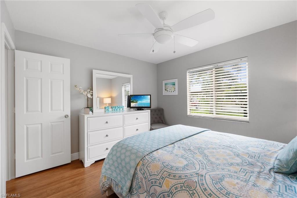 4572 Andover Way, Unit C105 Naples, FL 34112 - Photo 17 of 50 a bedroom with a large bed and a window
