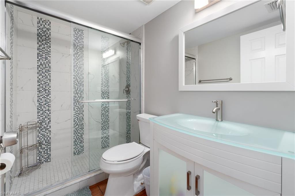 4572 Andover Way, Unit C105 Naples, FL 34112 - Photo 19 of 50 a bathroom with a sink a toilet and shower
