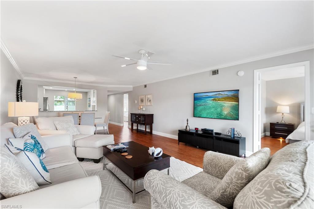 4572 Andover Way, Unit C105 Naples, FL 34112 - Photo 28 of 50 a living room with furniture and a flat screen tv