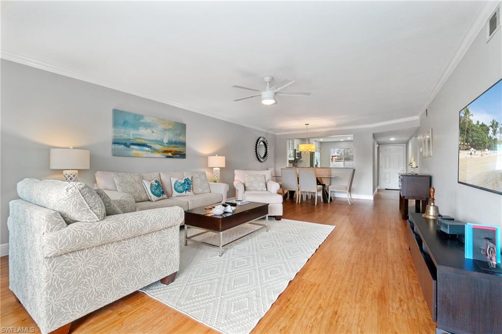 4572 Andover Way, Unit C105 Naples, FL 34112 - Photo 29 of 50 a living room with furniture rug and window