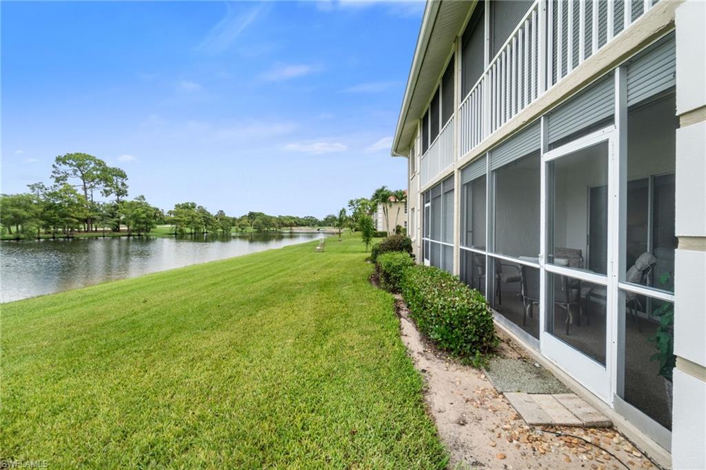 4572 Andover Way, Unit C105 Naples, FL 34112 - Photo 32 of 50 a view of a garden with a building in the background