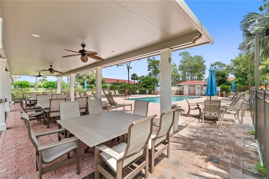 4572 Andover Way, Unit C105 Naples, FL 34112 - Photo 33 of 50 a view of a patio with a dining table and chairs
