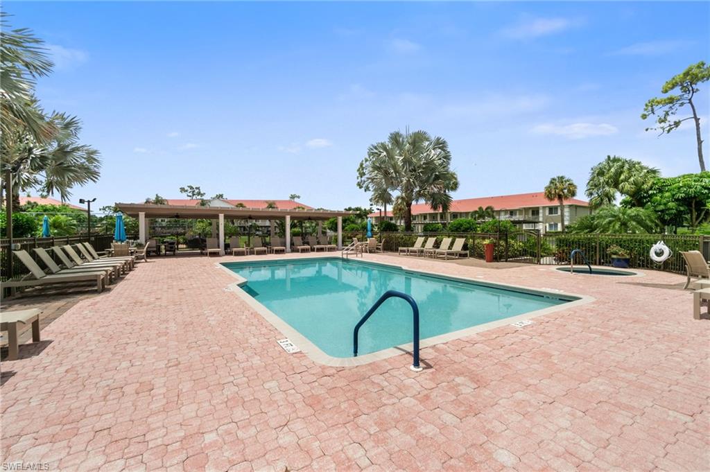 4572 Andover Way, Unit C105 Naples, FL 34112 - Photo 38 of 50 a view of a swimming pool with a yard