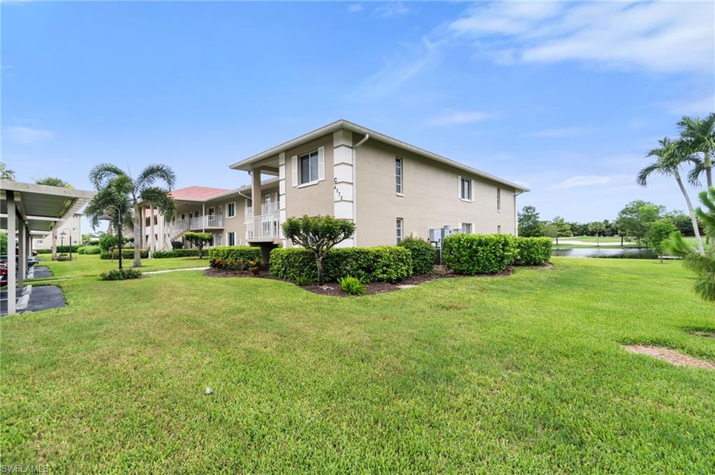 4572 Andover Way, Unit C105 Naples, FL 34112 - Photo 4 of 50 a front view of a house with garden