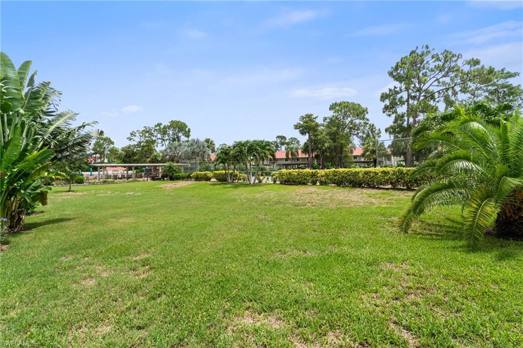 4572 Andover Way, Unit C105 Naples, FL 34112 - Photo 42 of 50 a view of a garden
