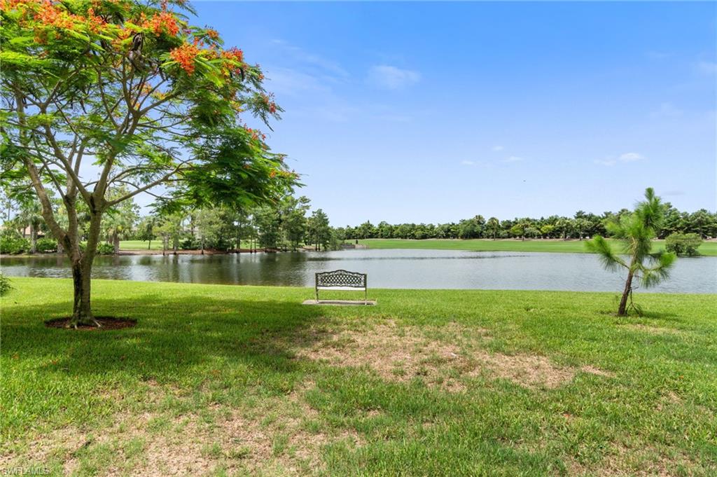 4572 Andover Way, Unit C105 Naples, FL 34112 - Photo 43 of 50 a view of a lake with a yard