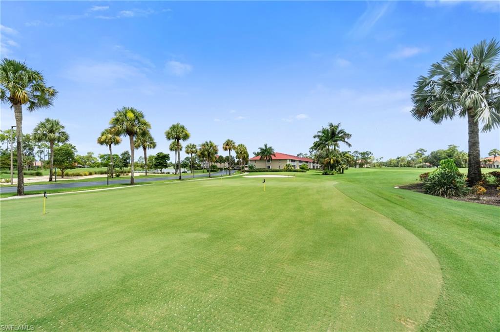 4572 Andover Way, Unit C105 Naples, FL 34112 - Photo 49 of 50 a garden with trees in the background