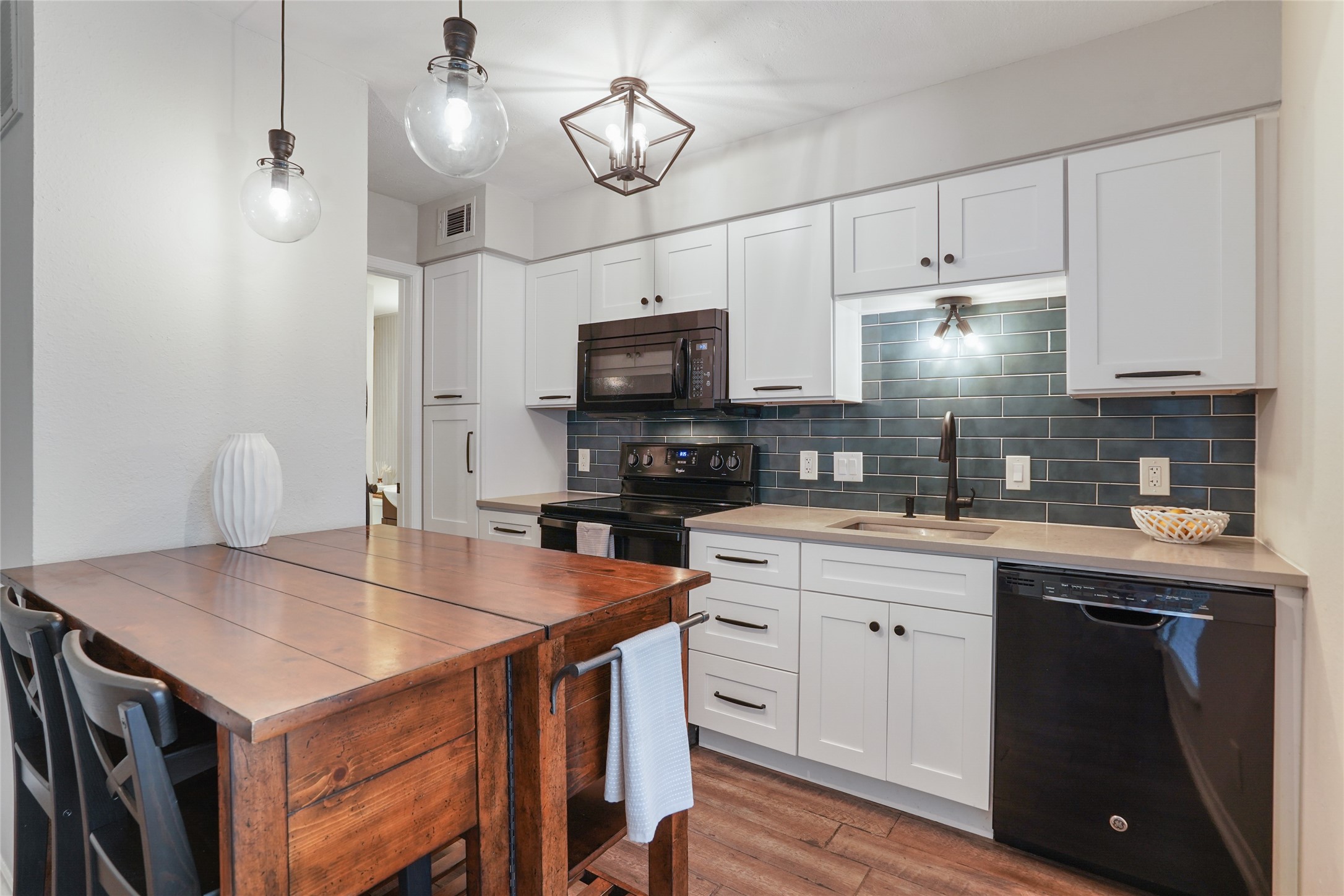 3115 Helms Street, Unit 118 Austin, TX 78705 - Photo 1 of 1 Updated kitchen is open to the living area. Wood island and bar stools convey.