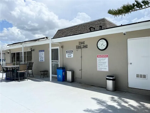 a view of swimming pool with seating space and fir pit