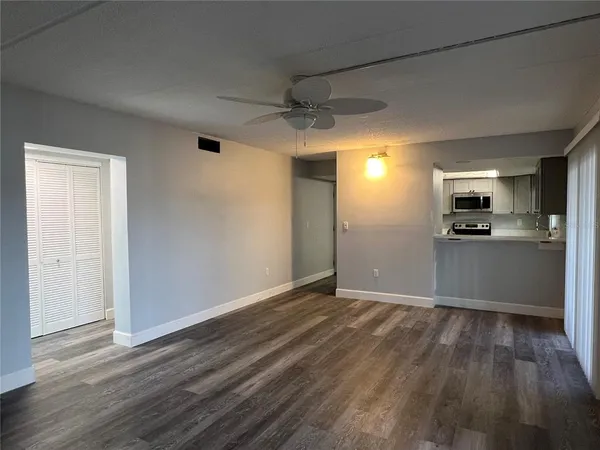 a view of a kitchen with a wooden floor and a kitchen