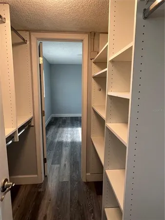an empty room with wooden floor and closet