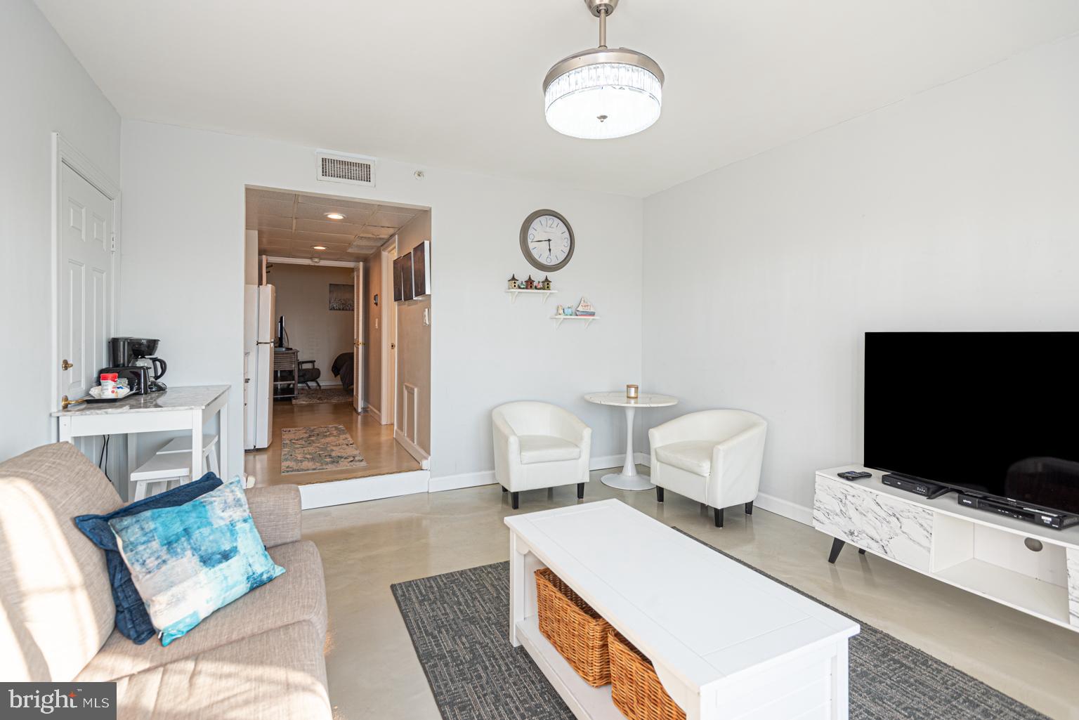 200 59th Street, Unit 209 Ocean City, MD 21842 - Photo 11 of 49 a living room with furniture and a flat screen tv