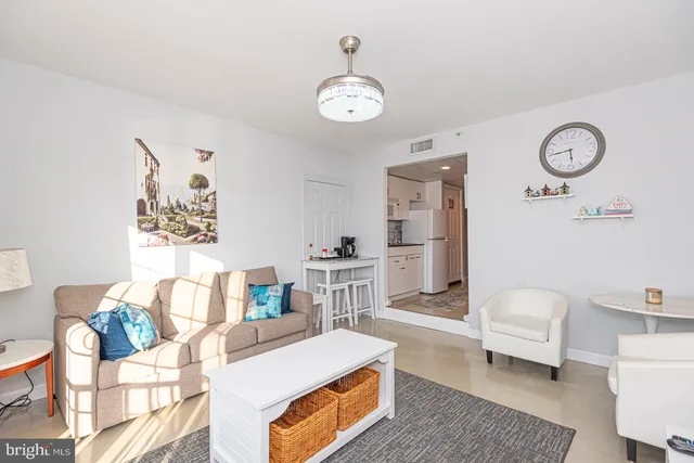 a living room with furniture and a clock