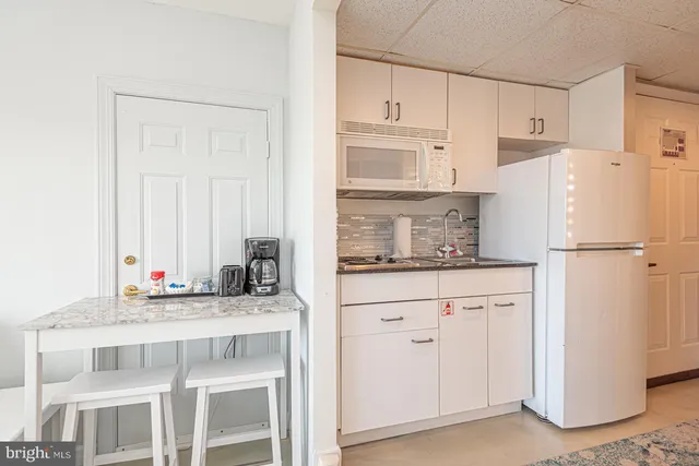 a kitchen with stainless steel appliances granite countertop a refrigerator sink and cabinets