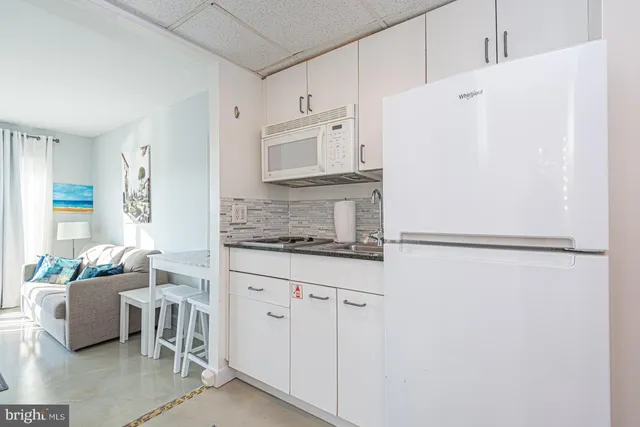 a white refrigerator freezer sitting inside of a kitchen
