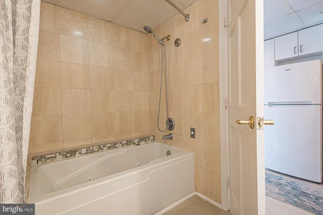 a bathroom with a bathtub and a shower