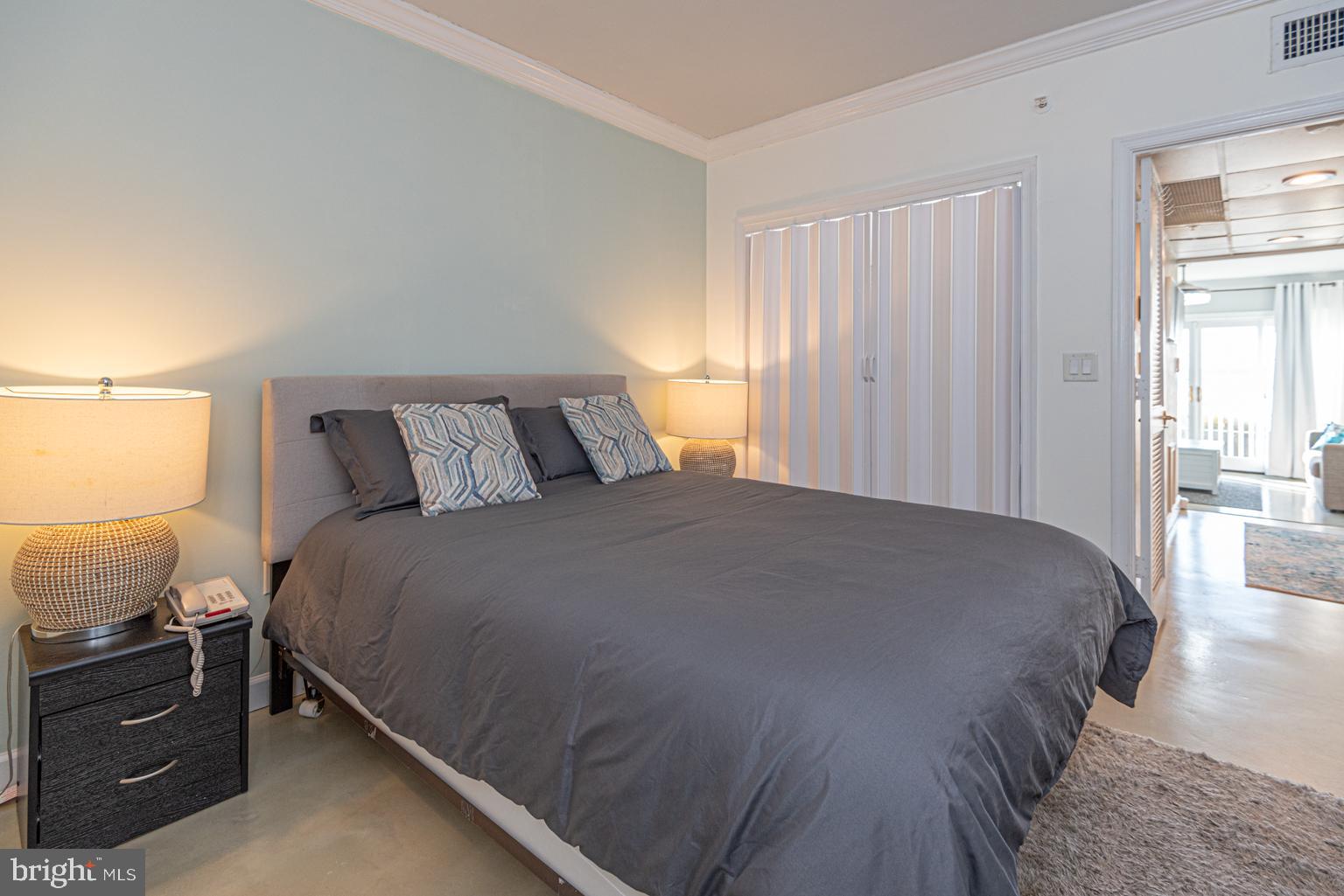 200 59th Street, Unit 209 Ocean City, MD 21842 - Photo 23 of 49 a bedroom with a bed and window