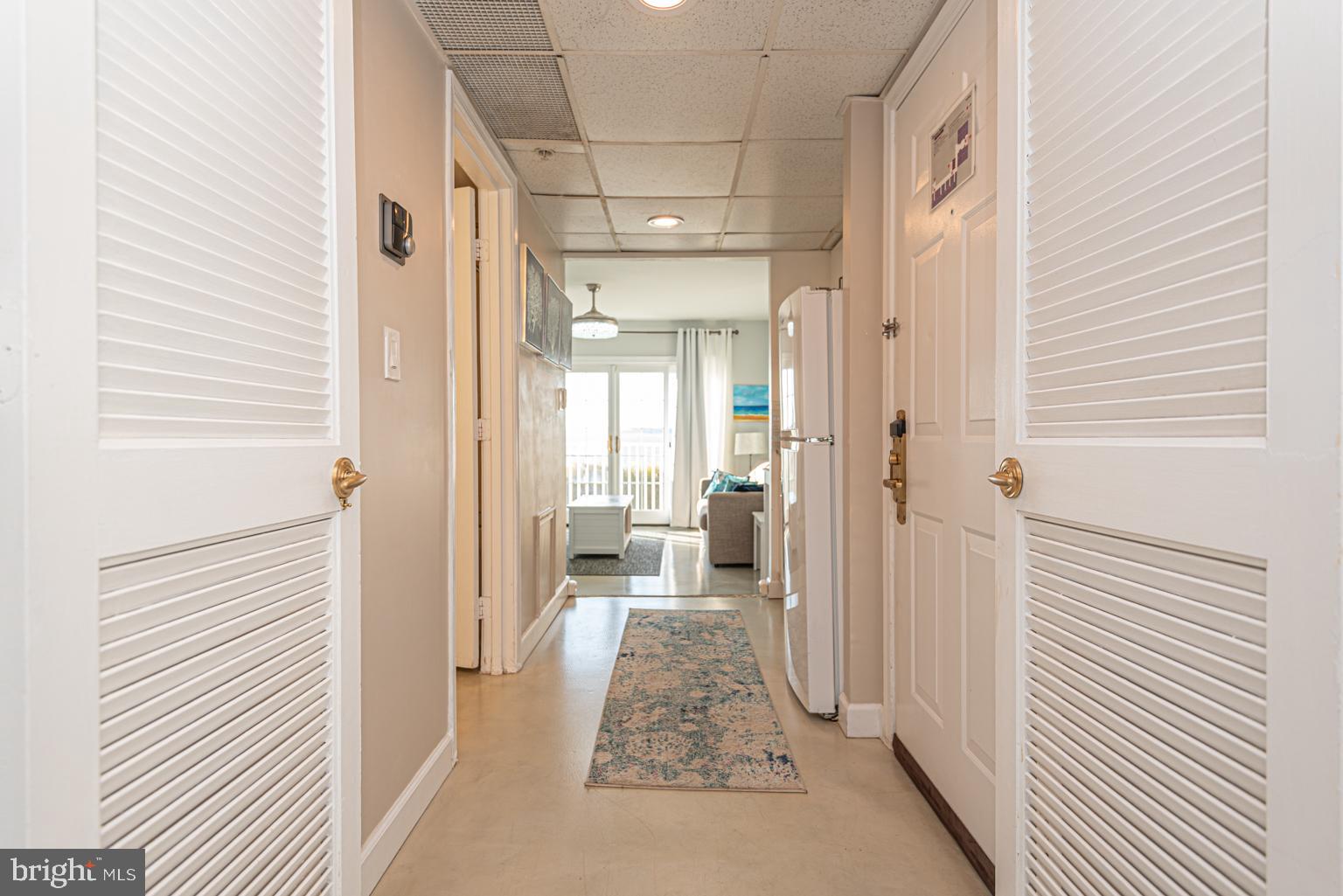 200 59th Street, Unit 209 Ocean City, MD 21842 - Photo 25 of 49 a view of a hallway with a livingroom and fireplace