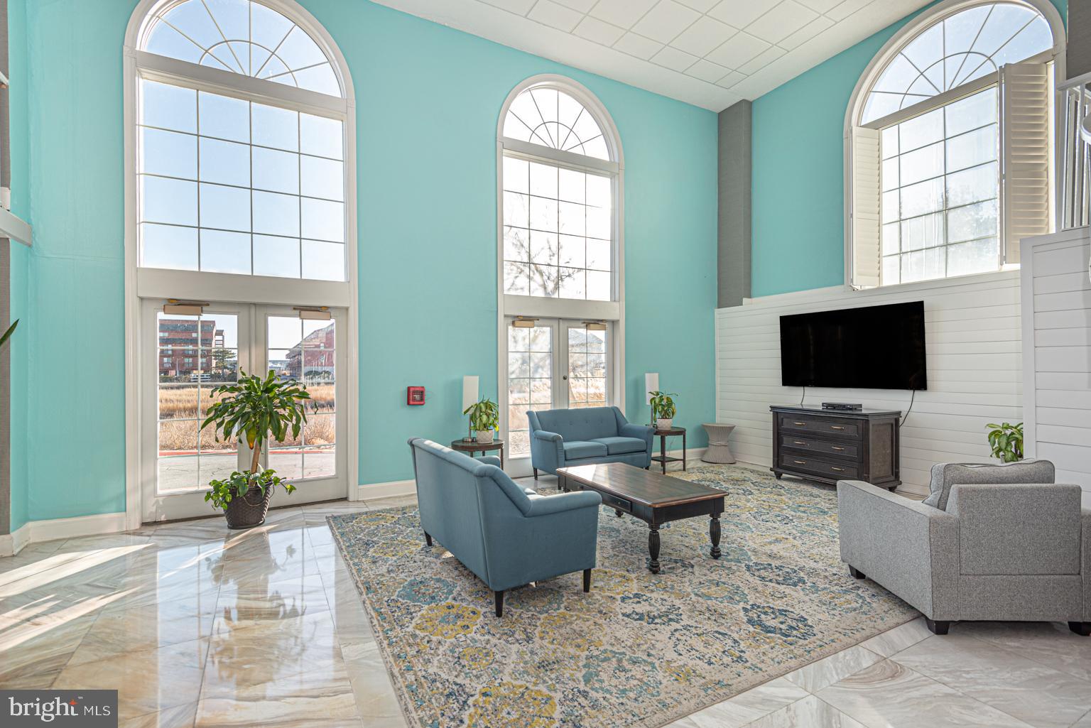 200 59th Street, Unit 209 Ocean City, MD 21842 - Photo 31 of 49 a living room with furniture and a flat screen tv