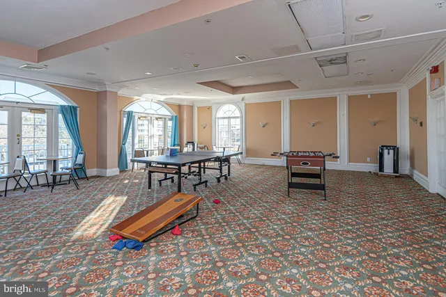 a living room with furniture a flat screen tv and a table