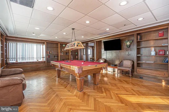 a room with furniture and pool table