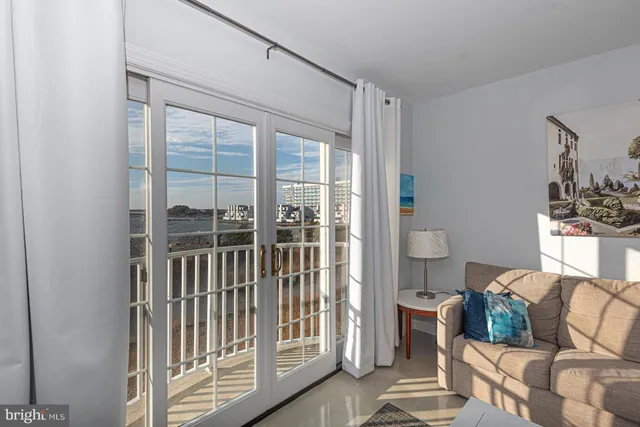 a living room with furniture and a floor to ceiling window