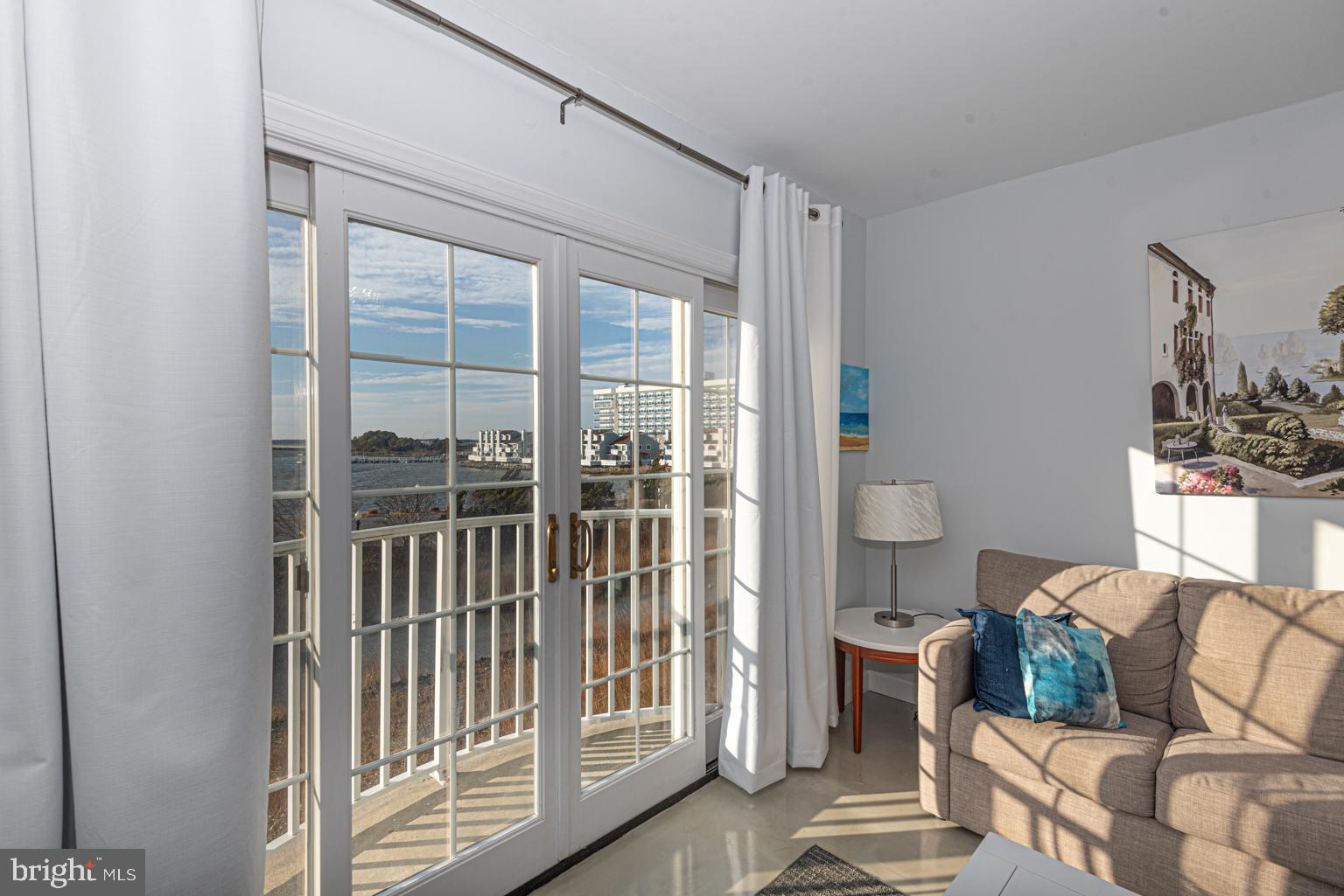 200 59th Street, Unit 209 Ocean City, MD 21842 - Photo 5 of 49 a living room with furniture and a floor to ceiling window