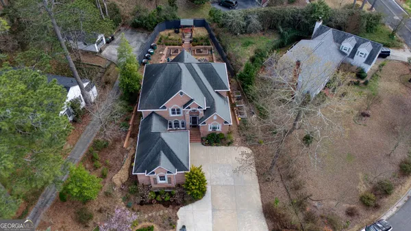 an aerial view of a house with outdoor space