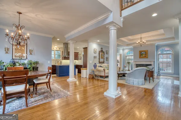 a living room with furniture a fireplace and a wooden floor