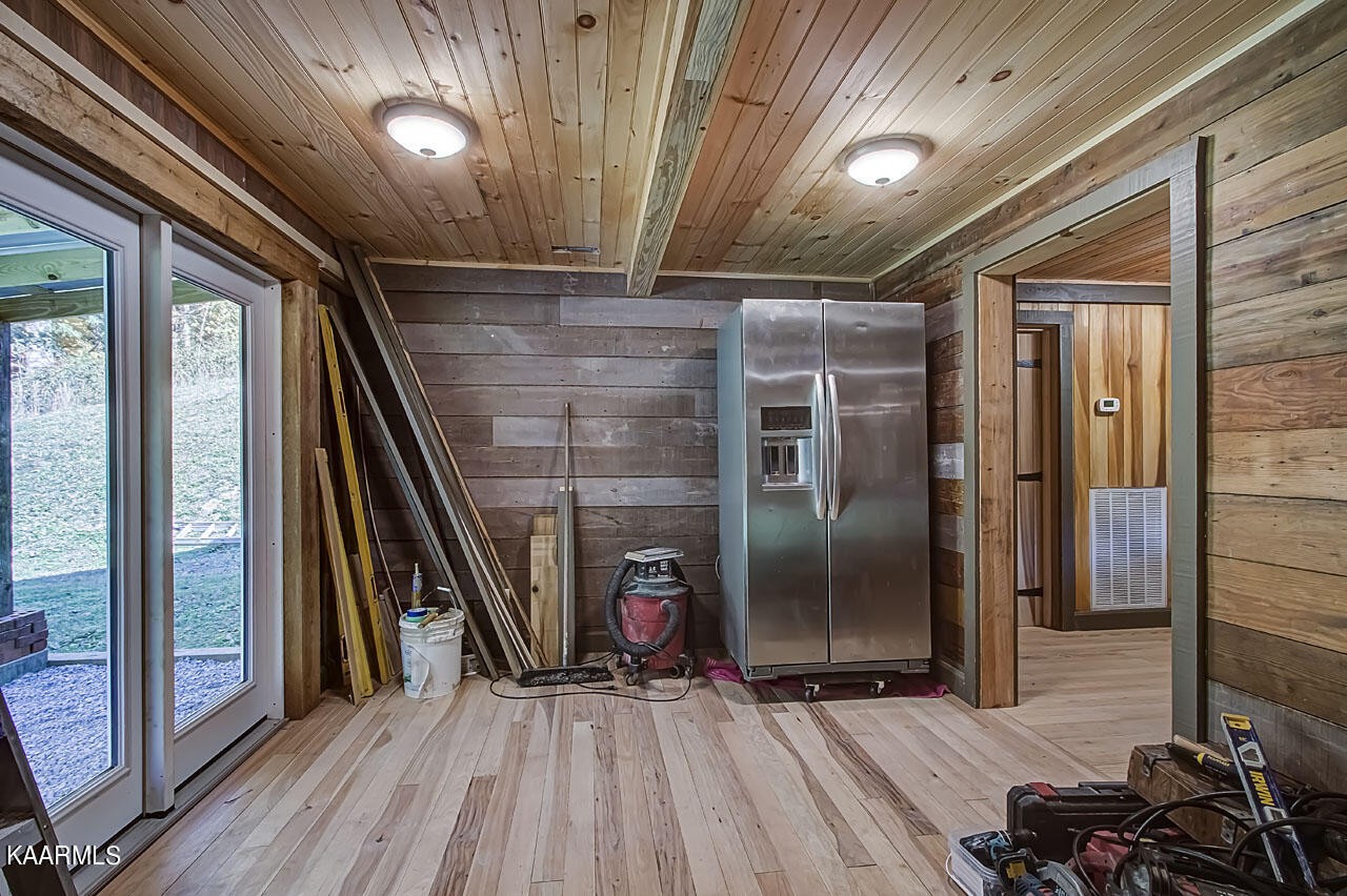 383 Peach Orchard Road Clinton, TN 37716 - Photo 15 of 58 a view of empty room with wooden floor
