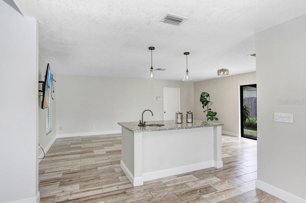 4412 Stonehenge Road Tampa, FL 33624 - Photo 11 of 33 a kitchen with granite countertop a sink and cabinets