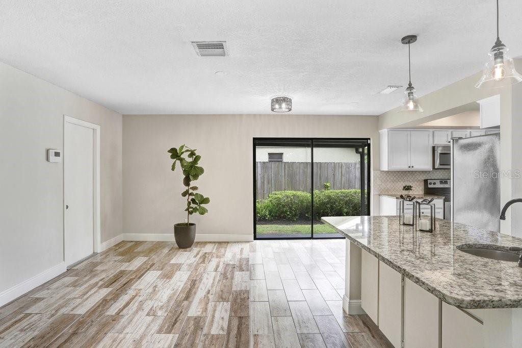 4412 Stonehenge Road Tampa, FL 33624 - Photo 12 of 33 a very nice looking room with a large window and chandelier