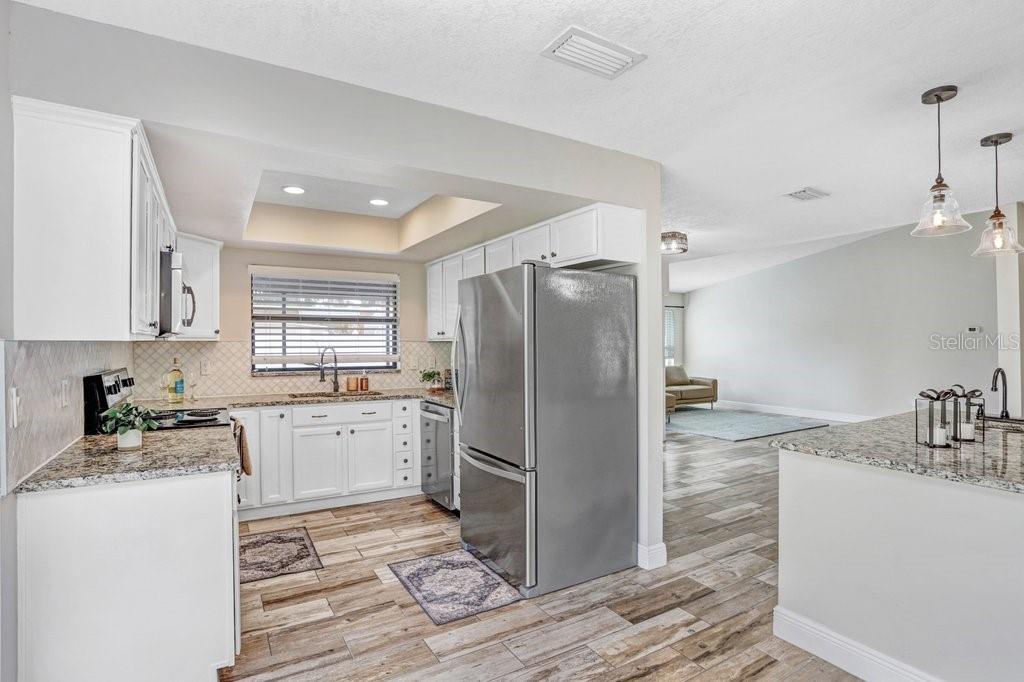 4412 Stonehenge Road Tampa, FL 33624 - Photo 14 of 33 a kitchen with a sink stove and refrigerator