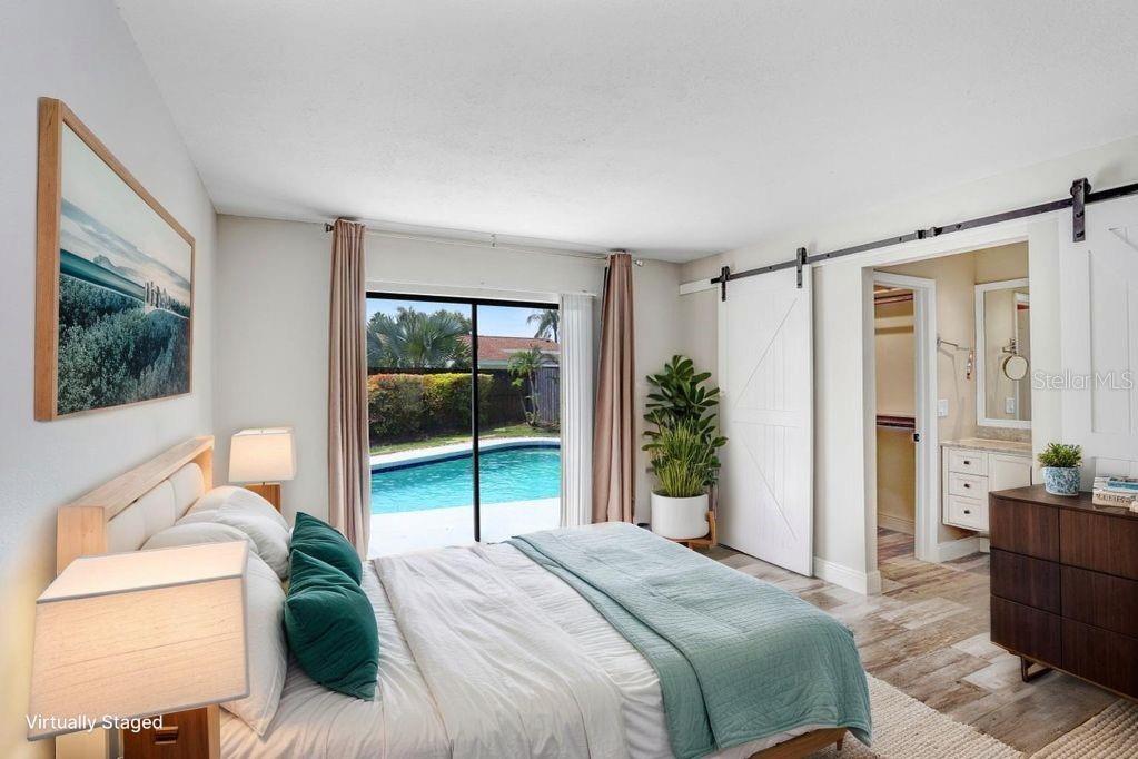 4412 Stonehenge Road Tampa, FL 33624 - Photo 16 of 33 a bedroom with a bed and a large window