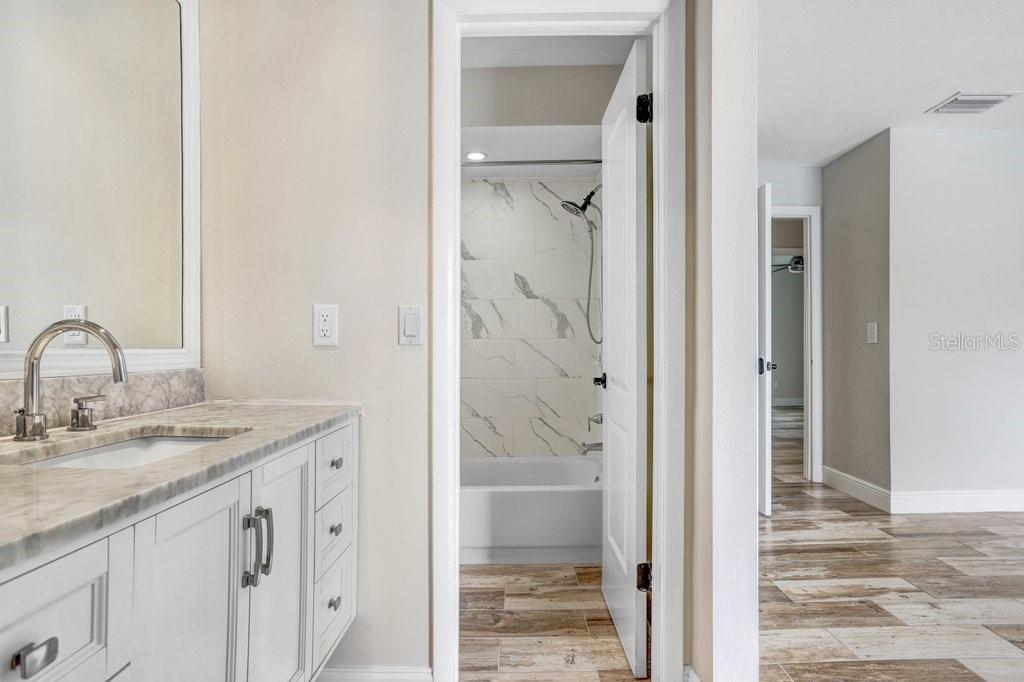 4412 Stonehenge Road Tampa, FL 33624 - Photo 21 of 33 a bathroom with a granite countertop sink and a mirror